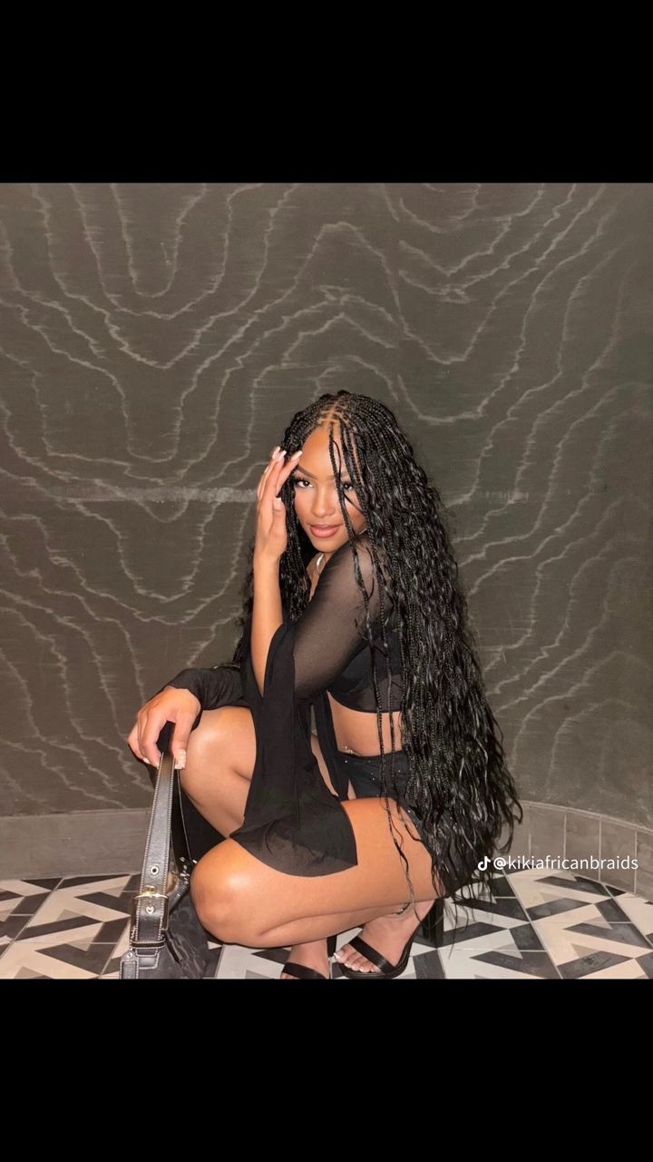 Long black bohemian goddess braids with wavy loose ends